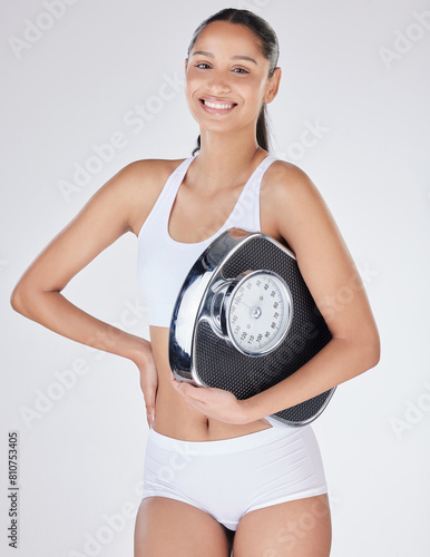 Girl  portrait and scale in studio for calories  smile and excited for results of diet or detox. Female person  underwear and happy for weight loss goals or progress  wellness and white background
