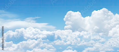 Beautiful white clouds floating in the clear blue sky creating a mesmerizing copy space image