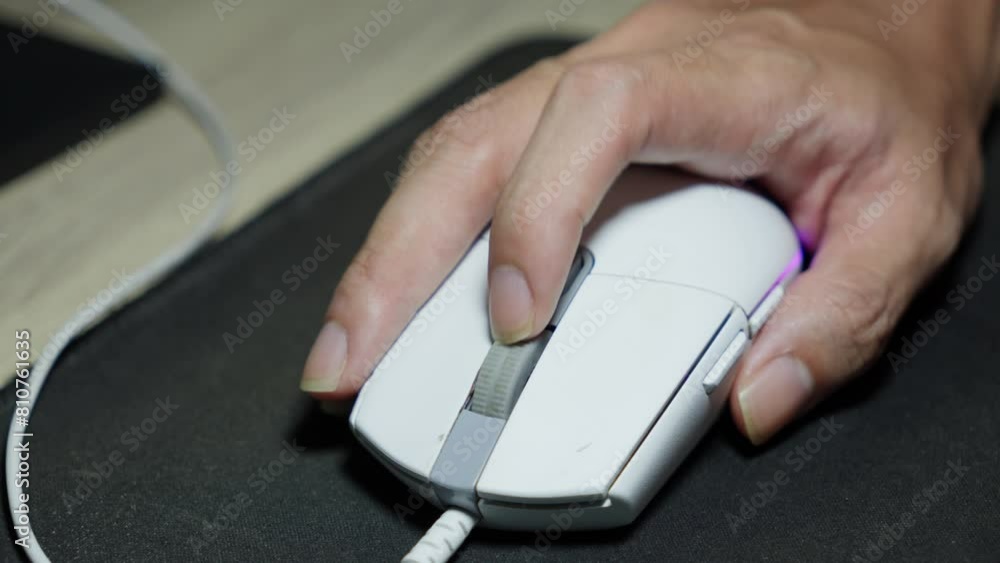 Hand scrolling down the mouse wheel on the computer. Close up Hand scrolling down the mouse wheel on the computer. Close up