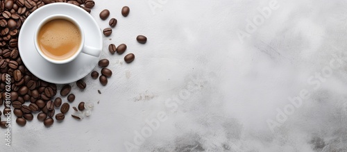 A copy space image of an espresso coffee with coffee beans captured on a serene grey stone background