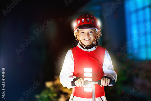 Fotografie Safety on dark street. Kids reflective vest.