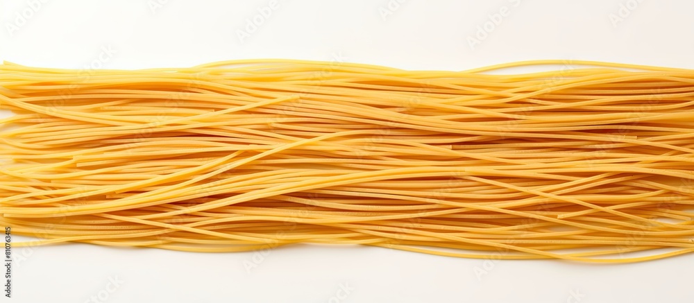 A group of spaghetti noodles arranged on a white background with ample copy space for adding additional images or text A group of spaghetti noodles arranged on a white background with ample copy space for adding additional images or text