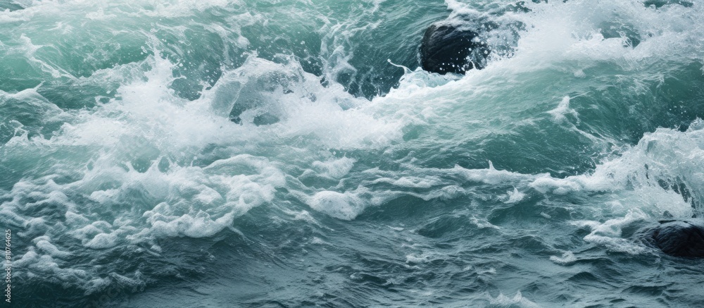 A close up copy space image of frothy water formed as a stream cascades