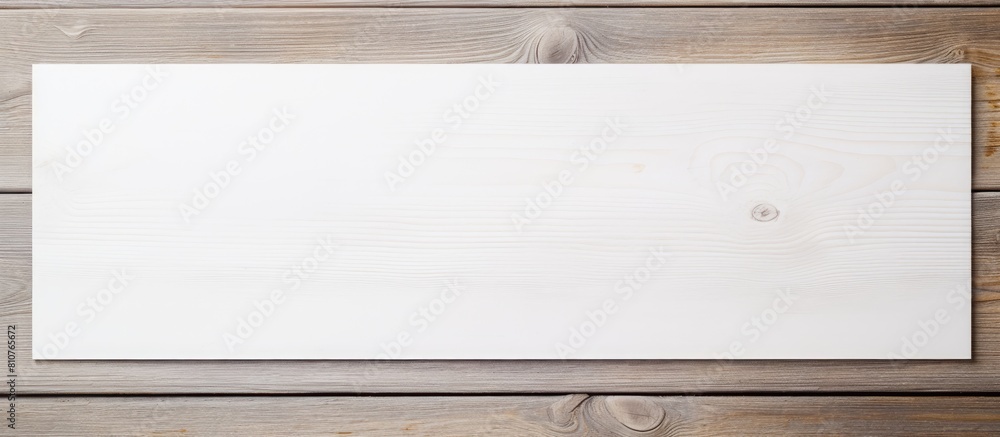 Top view of a white wooden background with a blank invitation card providing ample space for adding text Top view of a white wooden background with a blank invitation card providing ample space for adding text