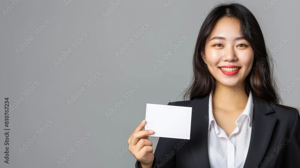 Professional Asian woman holding a white business card Fictional Character Created By Generative AI. Professional Asian woman holding a white business card Fictional Character Created By Generative AI.