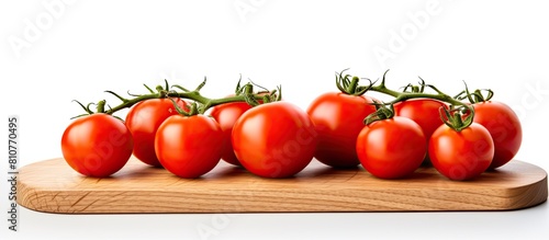 A minimal scene for advertising features fresh tomatoes adorned with a wooden cutting board against a white background creating a copy space image Tomatoes are beneficial for the skin helping to brig