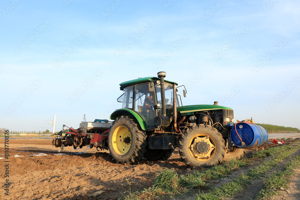 In spring, farmers use farm machinery to grow peanuts In spring, farmers use farm machinery to grow peanuts