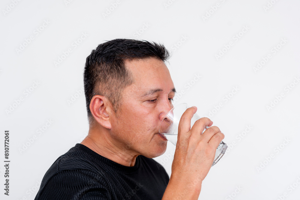Middle-aged Asian man drinking cold water, isolated on white background
