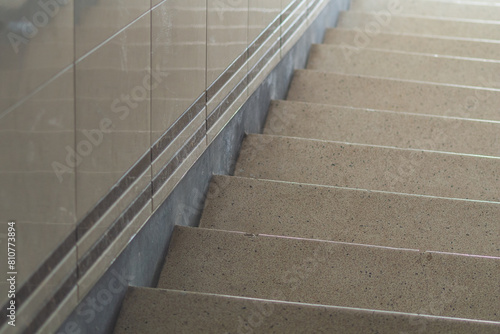 Detailed View of a Granite Staircase With Metal Handrail Inside a Building