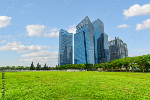 View of skyscrapers at downtown across green lawn in Singapore