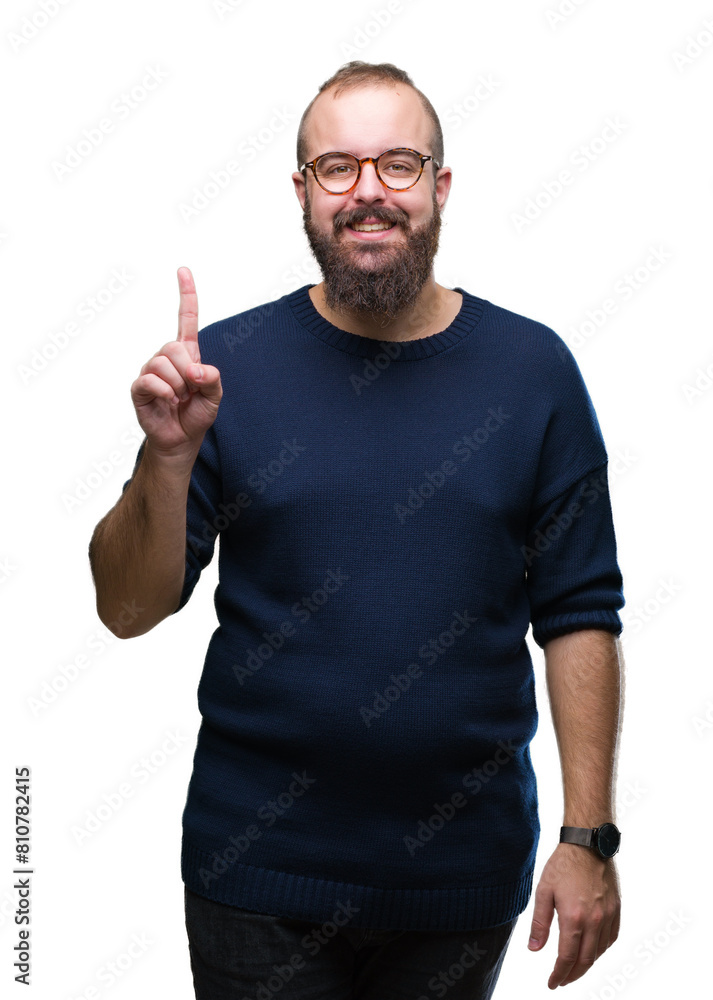 Young caucasian hipster man wearing sunglasses over isolated background showing and pointing up with finger number one while smiling confident and happy. Young caucasian hipster man wearing sunglasses over isolated background showing and pointing up with finger number one while smiling confident and happy.