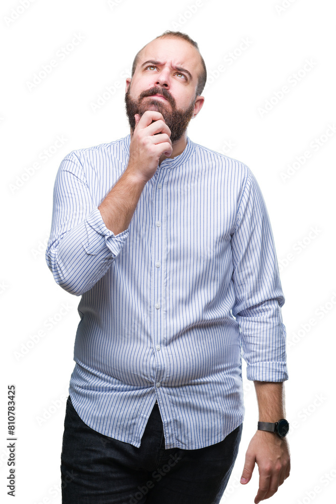 Young caucasian hipster man over isolated background with hand on chin thinking about question, pensive expression. Smiling with thoughtful face. Doubt concept. Young caucasian hipster man over isolated background with hand on chin thinking about question, pensive expression. Smiling with thoughtful face. Doubt concept.