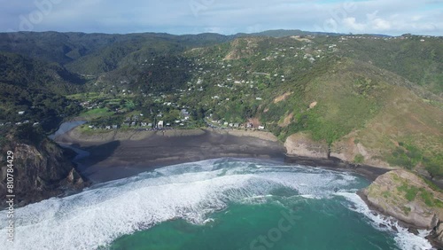 Aerial View Of Piha Beach, Lion Rock And Taitomo Island By The Blue Sea In West Auckland, New Zealand. photo