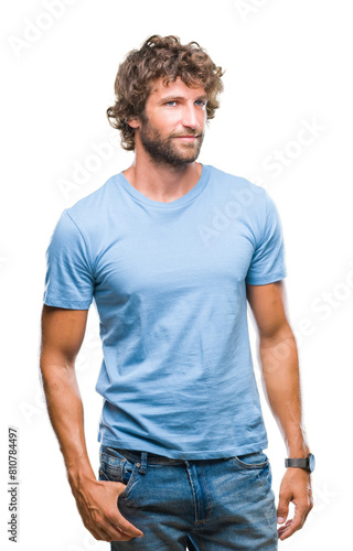 Handsome hispanic model man over isolated background looking away to side with smile on face, natural expression. Laughing confident.