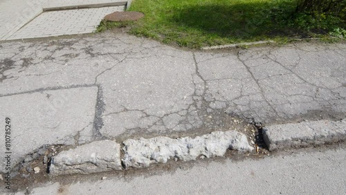 Deteriorating Gray Asphalt Footpath, Disappeared Verges, Potholes in Road, Poor Public Maintenance by Government photo