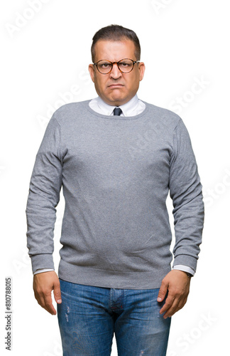Middle age bussines arab man wearing glasses over isolated background skeptic and nervous, frowning upset because of problem. Negative person.