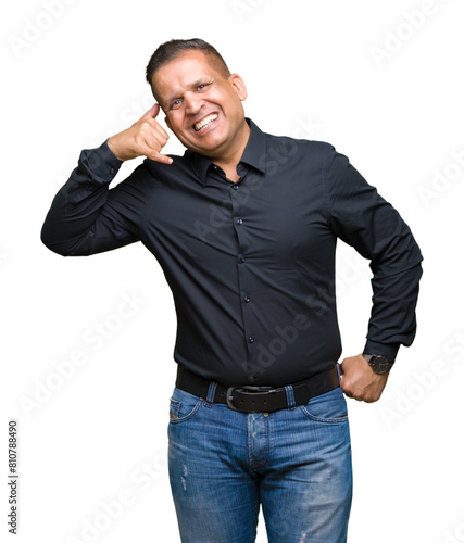 Handsome middle age arab business man over isolated background smiling doing phone gesture with hand and fingers like talking on the telephone. Communicating concepts.