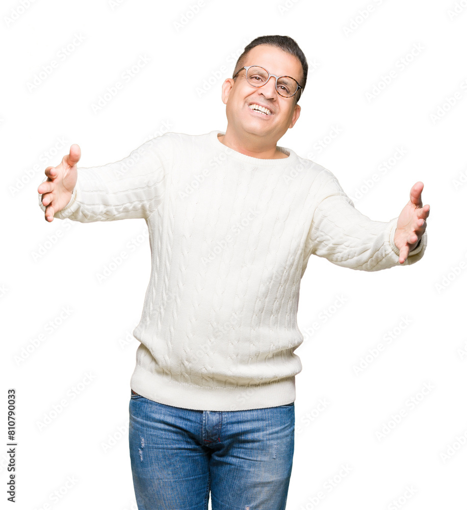 Middle age arab man wearing glasses over isolated background looking at the camera smiling with open arms for hug. Cheerful expression embracing happiness. Middle age arab man wearing glasses over isolated background looking at the camera smiling with open arms for hug. Cheerful expression embracing happiness.