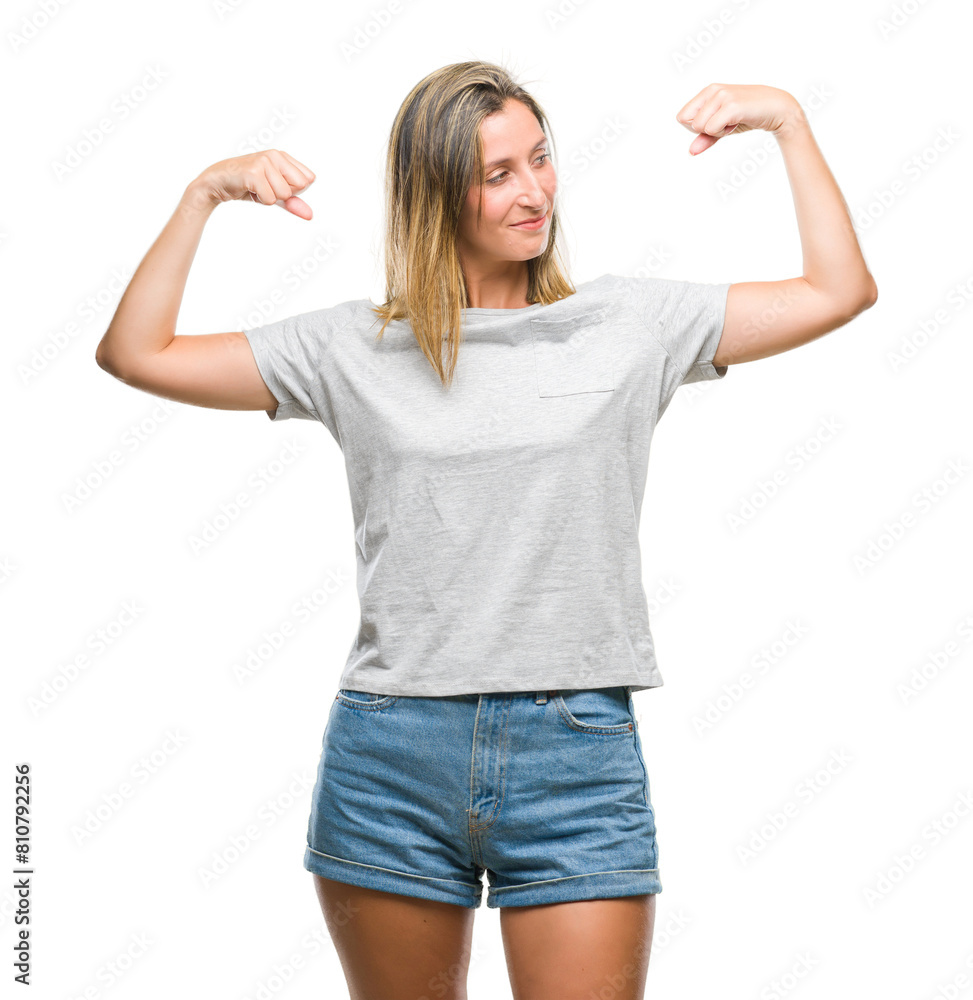 Fototapeta premium Young beautiful woman over isolated background showing arms muscles smiling proud. Fitness concept.