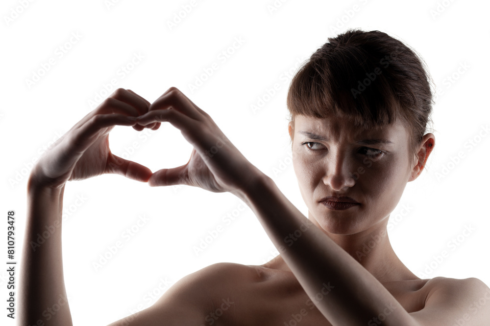 Obraz premium Young woman showcasing expressions, forming heart shape with hands against white background