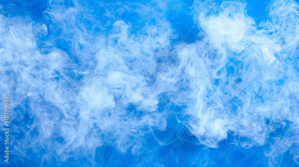 A blue sky with a thick cloud of smoke rising from the ground