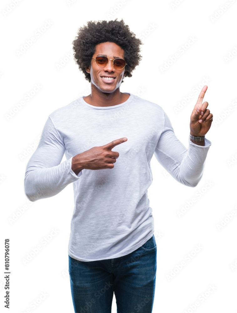 Afro american man wearing sunglasses over isolated background smiling and looking at the camera pointing with two hands and fingers to the side. Afro american man wearing sunglasses over isolated background smiling and looking at the camera pointing with two hands and fingers to the side.
