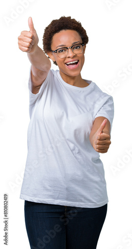 Beautiful young african american woman wearing glasses over isolated background approving doing positive gesture with hand, thumbs up smiling and happy for success. Looking at the camera