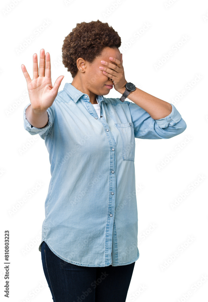 Young beautiful african american woman over isolated background covering eyes with hands and doing stop gesture with sad and fear expression. Embarrassed and negative concept. Young beautiful african american woman over isolated background covering eyes with hands and doing stop gesture with sad and fear expression. Embarrassed and negative concept.