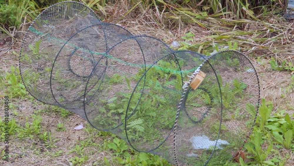 Fishing netting cage lies on the shore. Fishing netting cage lies on the shore.