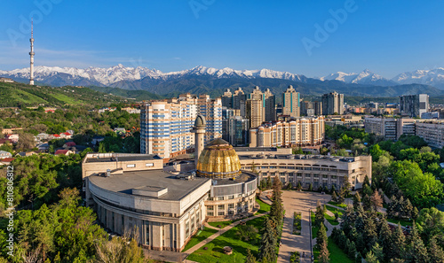 View from a quadcopter of the south-eastern part of the Kazakh city of Almaty against the backdrop of a mountain range on a sunny spring day