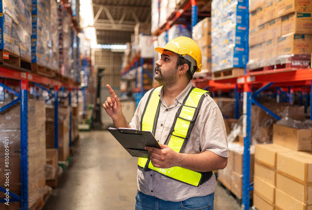 Portrait of male staff with holding clipboard working in warehouse, Industrial and industrial workers concept. Portrait of male staff with holding clipboard working in warehouse, Industrial and industrial workers concept.