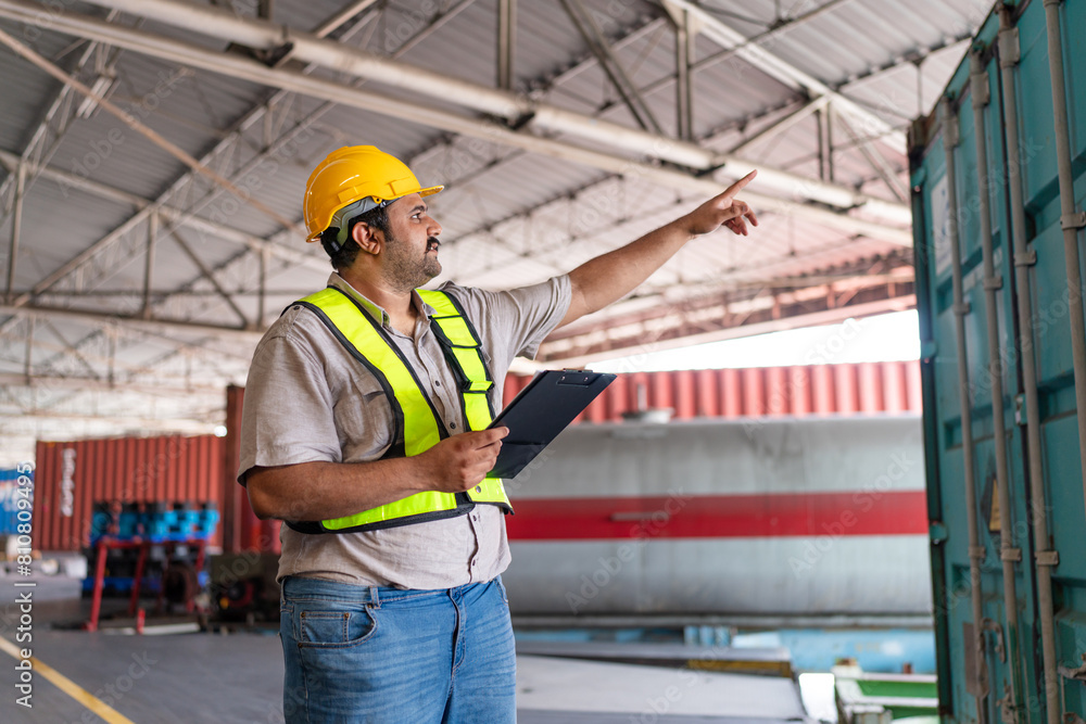 Portrait of male staff with holding clipboard working in warehouse, Industrial and industrial workers concept. Portrait of male staff with holding clipboard working in warehouse, Industrial and industrial workers concept.