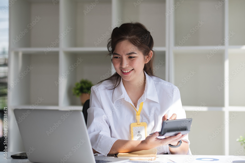 Business woman using calculator for do math finance on wooden desk in office and business working background, tax, accounting, statistics and analytic research concept. Business woman using calculator for do math finance on wooden desk in office and business working background, tax, accounting, statistics and analytic research concept.
