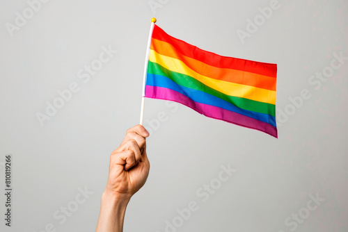 Hand waving rainbow LGBTQIA pride flag