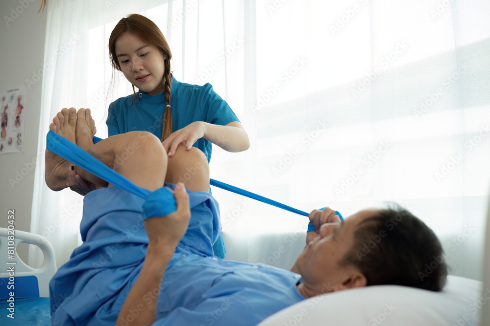 a woman in a blue uniform helps a man in a hospital bed a woman in a blue uniform helps a man in a hospital bed