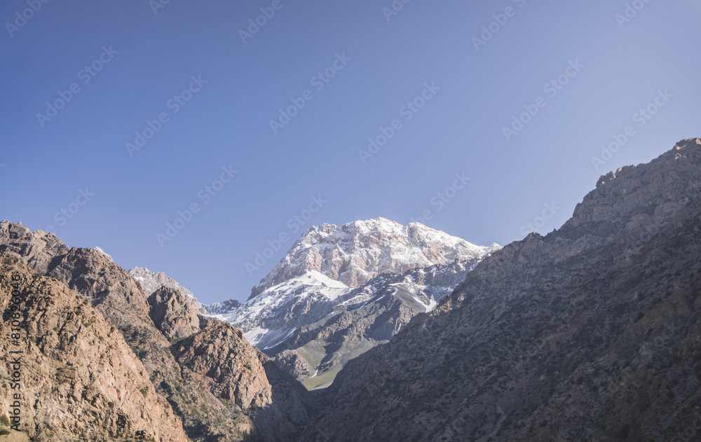Mountain range of rocks covered with snow and glaciers, atmospheric mountain landscape for background, texture of rocky mountains