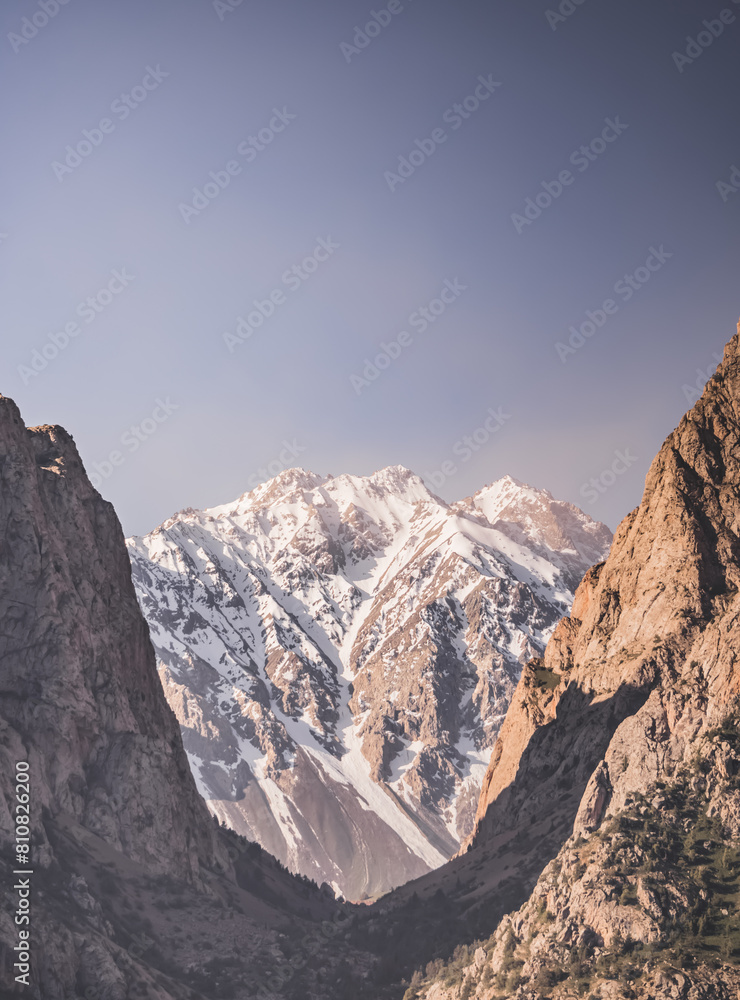 Mountain range of rocks covered with snow and glaciers, atmospheric mountain landscape for background, texture of rocky mountains