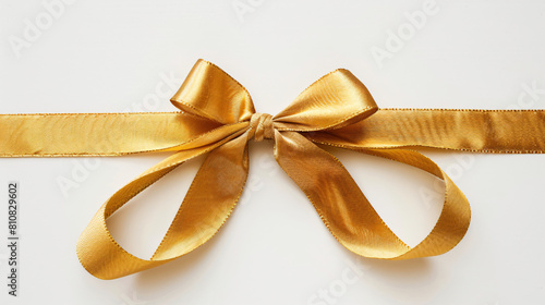 Golden ribbon tied in bow on white background