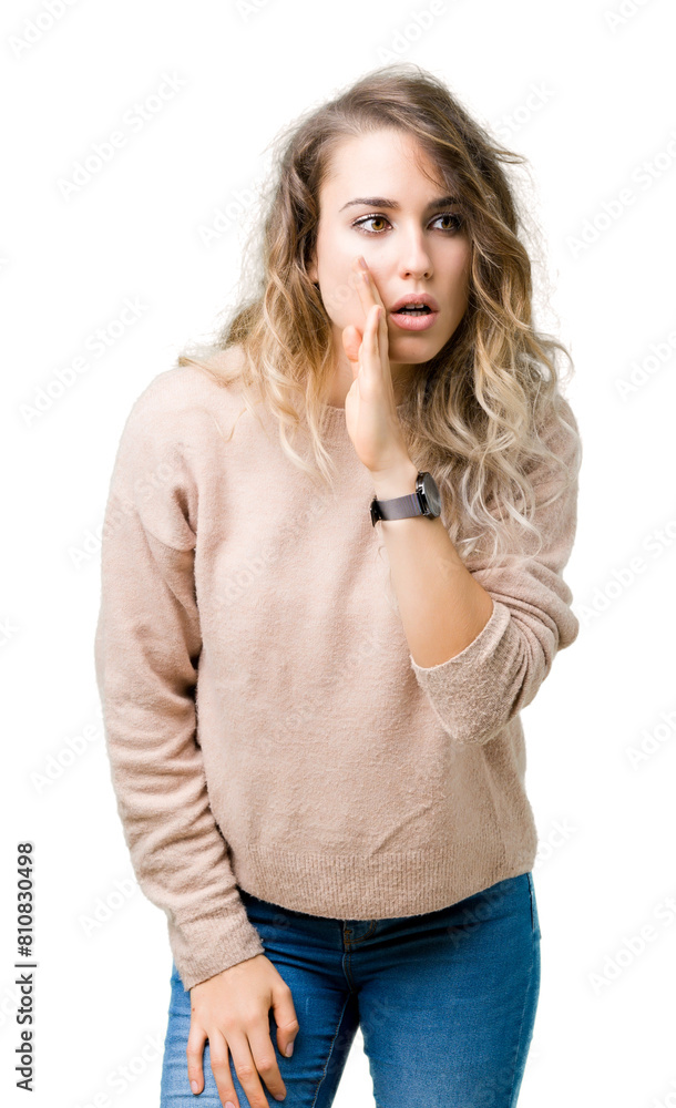 Beautiful young blonde woman wearing sweatershirt over isolated background hand on mouth telling secret rumor, whispering malicious talk conversation Beautiful young blonde woman wearing sweatershirt over isolated background hand on mouth telling secret rumor, whispering malicious talk conversation