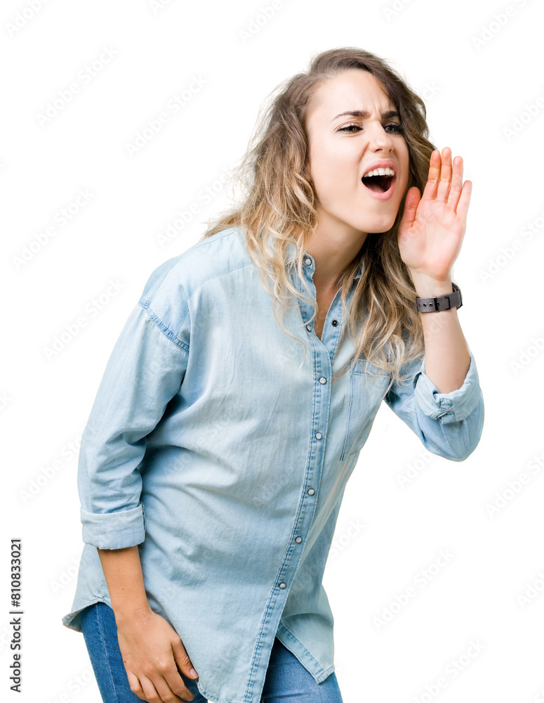 Beautiful young blonde woman over isolated background shouting and screaming loud to side with hand on mouth. Communication concept. Beautiful young blonde woman over isolated background shouting and screaming loud to side with hand on mouth. Communication concept.