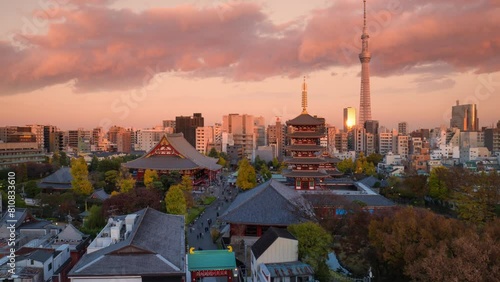 tokyo skyline time lapse day to night view of traditional temple with modern buildings and skytree tower in the background,timelapse starts at sunset photo