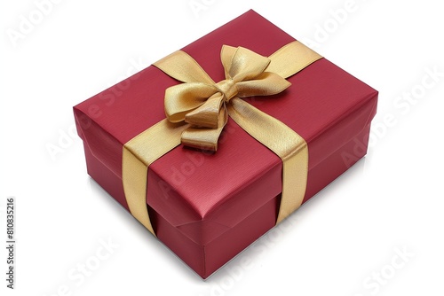 A luxurious red gift box tied with a shiny golden ribbon against a white background, symbolizing celebration and giving