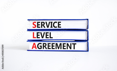 SLA service level agreement symbol. Concept words SLA service level agreement on beautiful books. Beautiful white background. Business SLA service level agreement concept. Copy space.