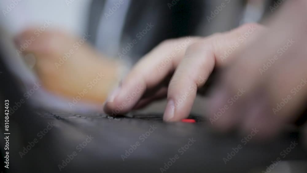 Close-up of hands typing rapidly on a laptop keyboard, focus on fingers and keys Close-up of hands typing rapidly on a laptop keyboard, focus on fingers and keys