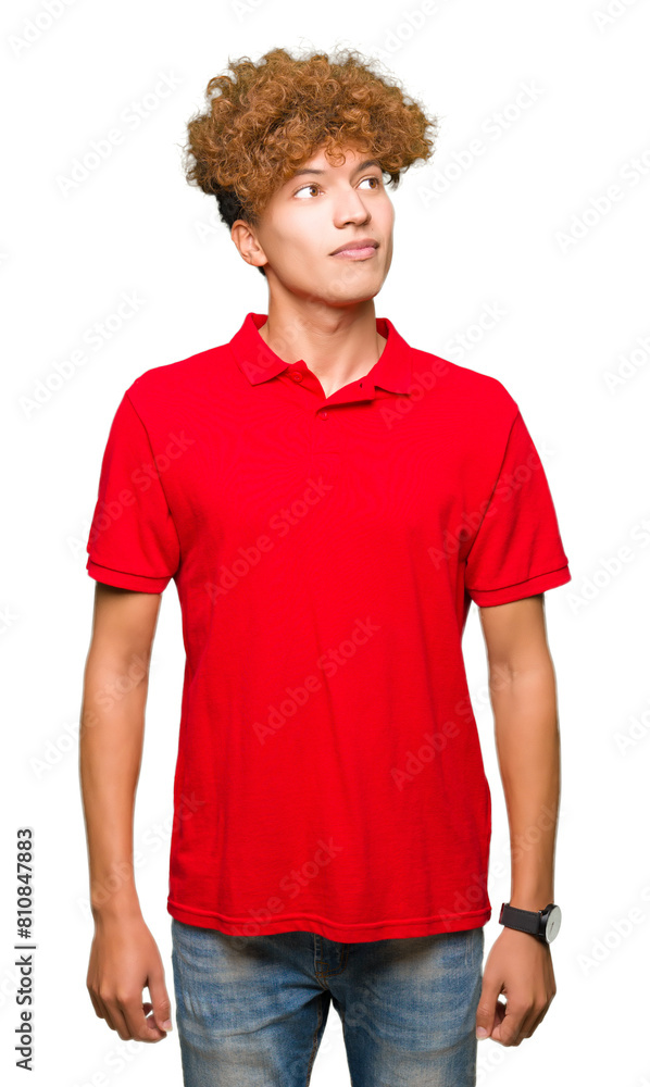 Young handsome man with afro hair wearing red t-shirt smiling looking side and staring away thinking. Young handsome man with afro hair wearing red t-shirt smiling looking side and staring away thinking.