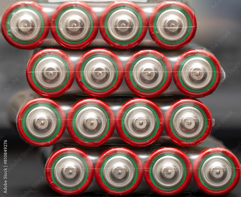 Close-up view of aa batteries stacked in symmetrical rows with vibrant red and green labels Close-up view of aa batteries stacked in symmetrical rows with vibrant red and green labels