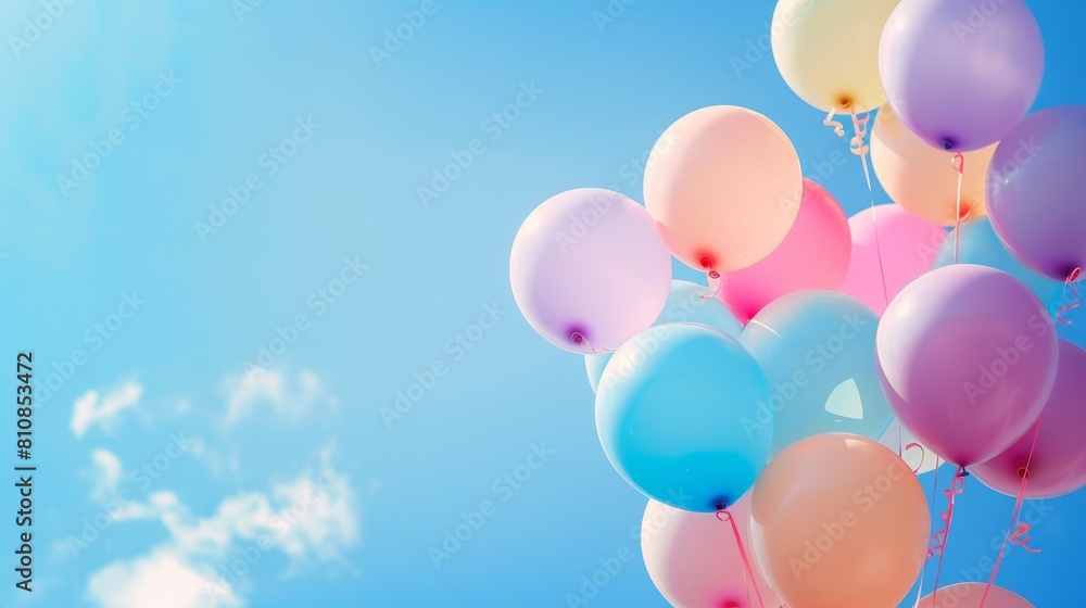 A bunch of balloons are floating in the sky above a blue sky A bunch of balloons are floating in the sky above a blue sky