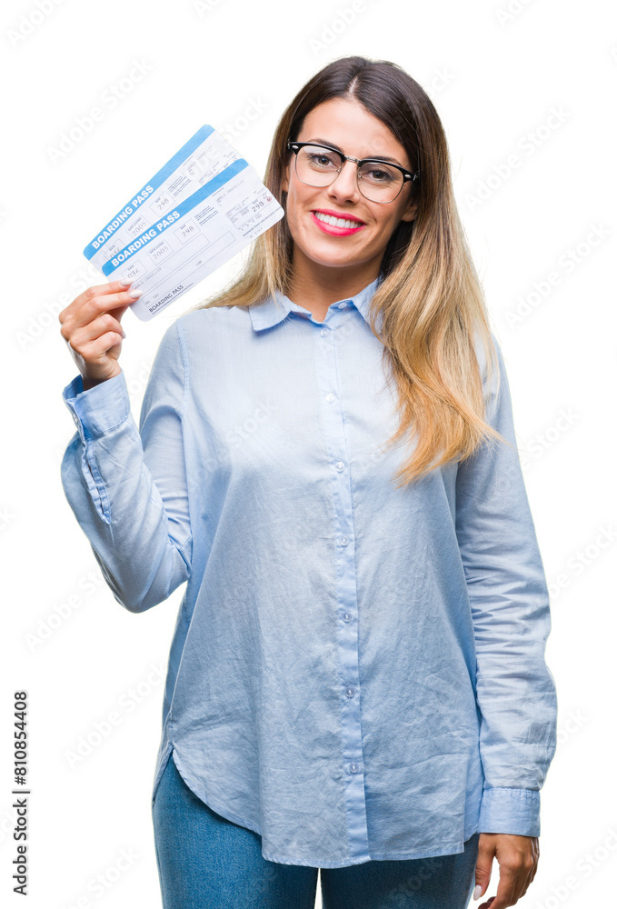 Young beautiful woman holding boarding pass over isolated background with a happy face standing and smiling with a confident smile showing teeth