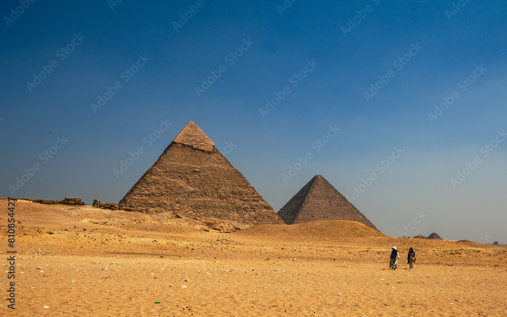 Two lone travellers at the Great Pyramids of Giza