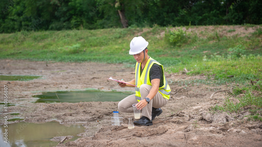 Environmental engineer Sit down next to a well and take the plastic glass of water sample to analysing check the quality and contaminants in the water source. Environmental engineer Sit down next to a well and take the plastic glass of water sample to analysing check the quality and contaminants in the water source.